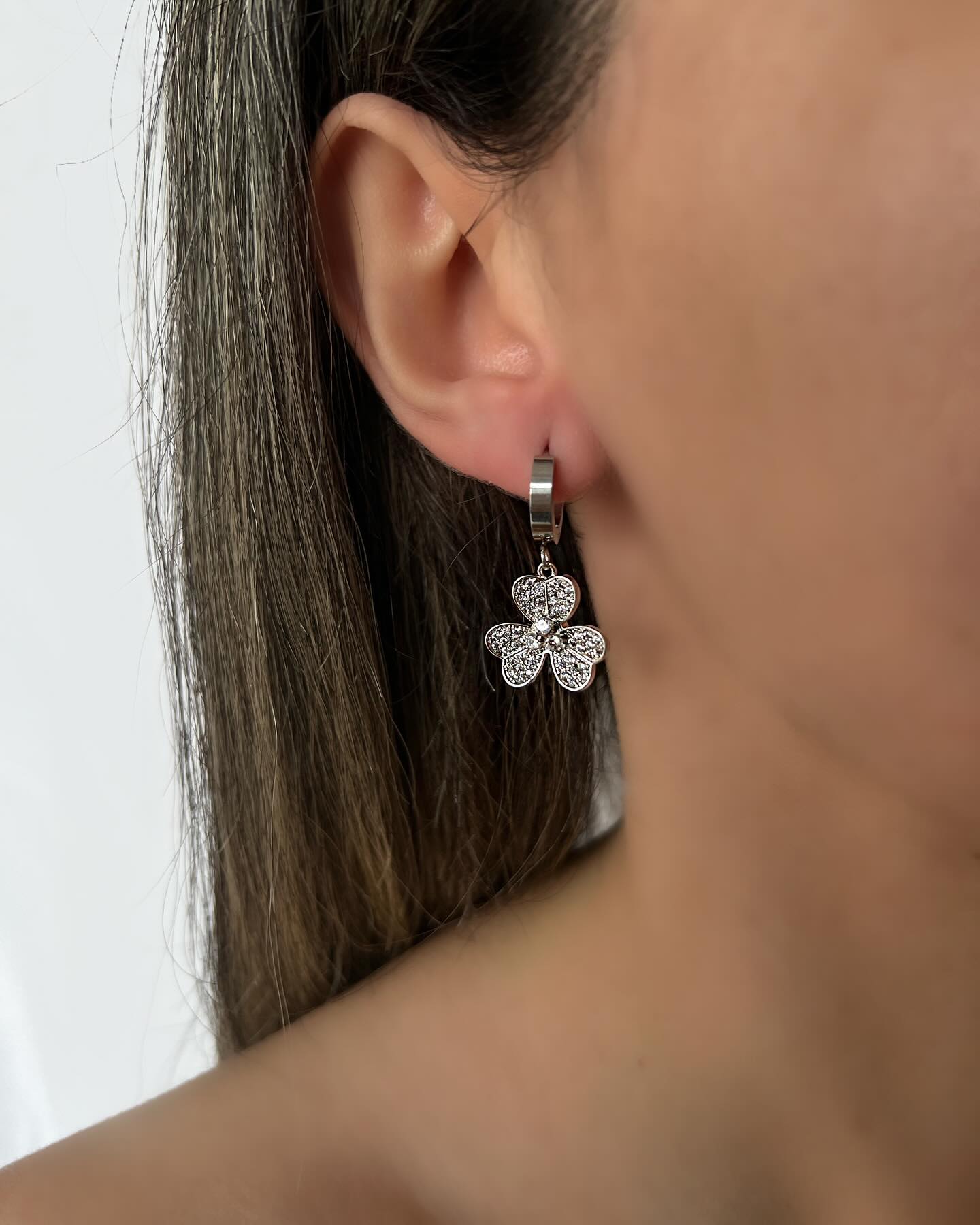 Clover leaf design with diamond accents, a charming pair of earrings that brings luck and sparkle.