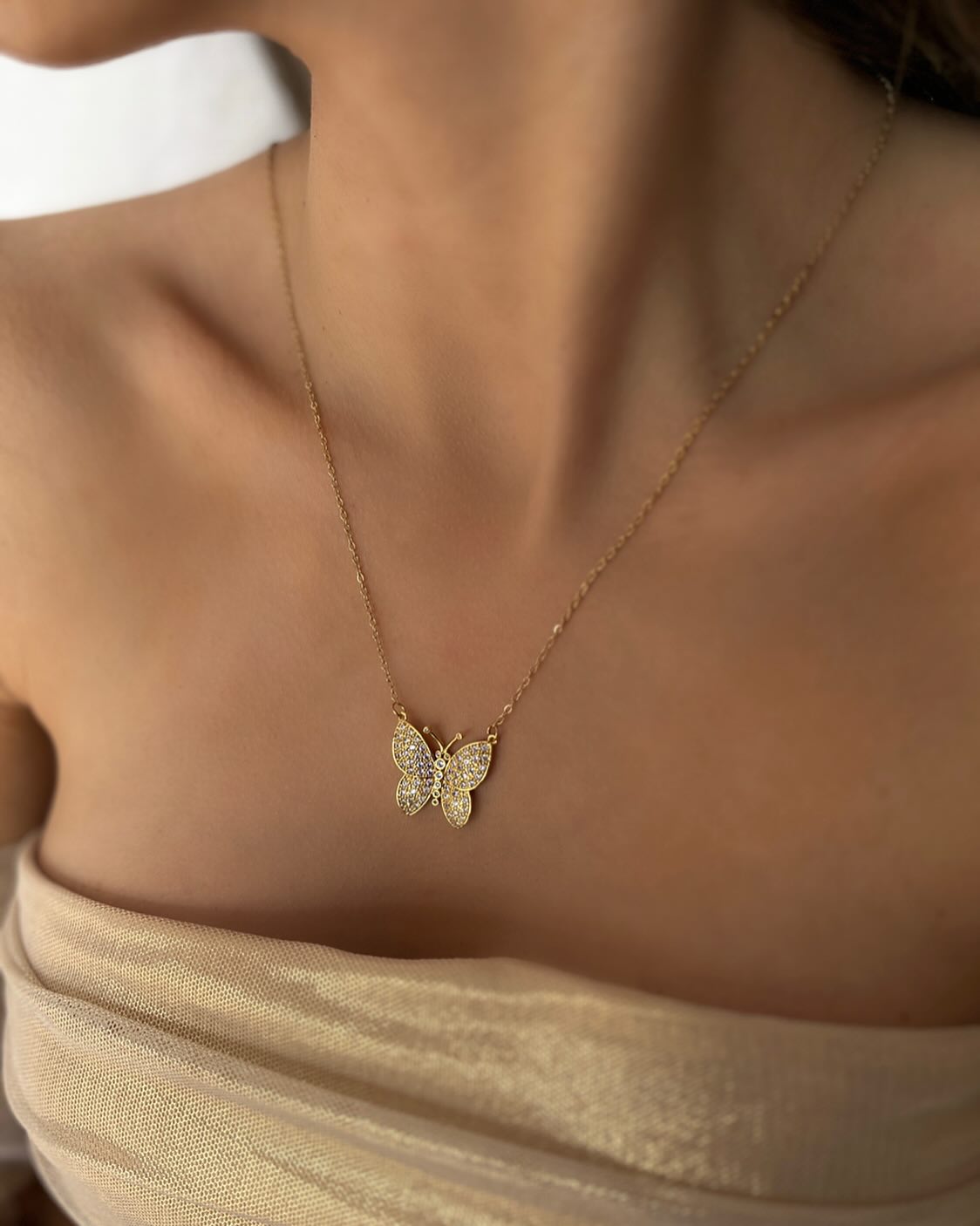 Butterfly charm with diamond accents, a graceful necklace that sparkles with elegance.