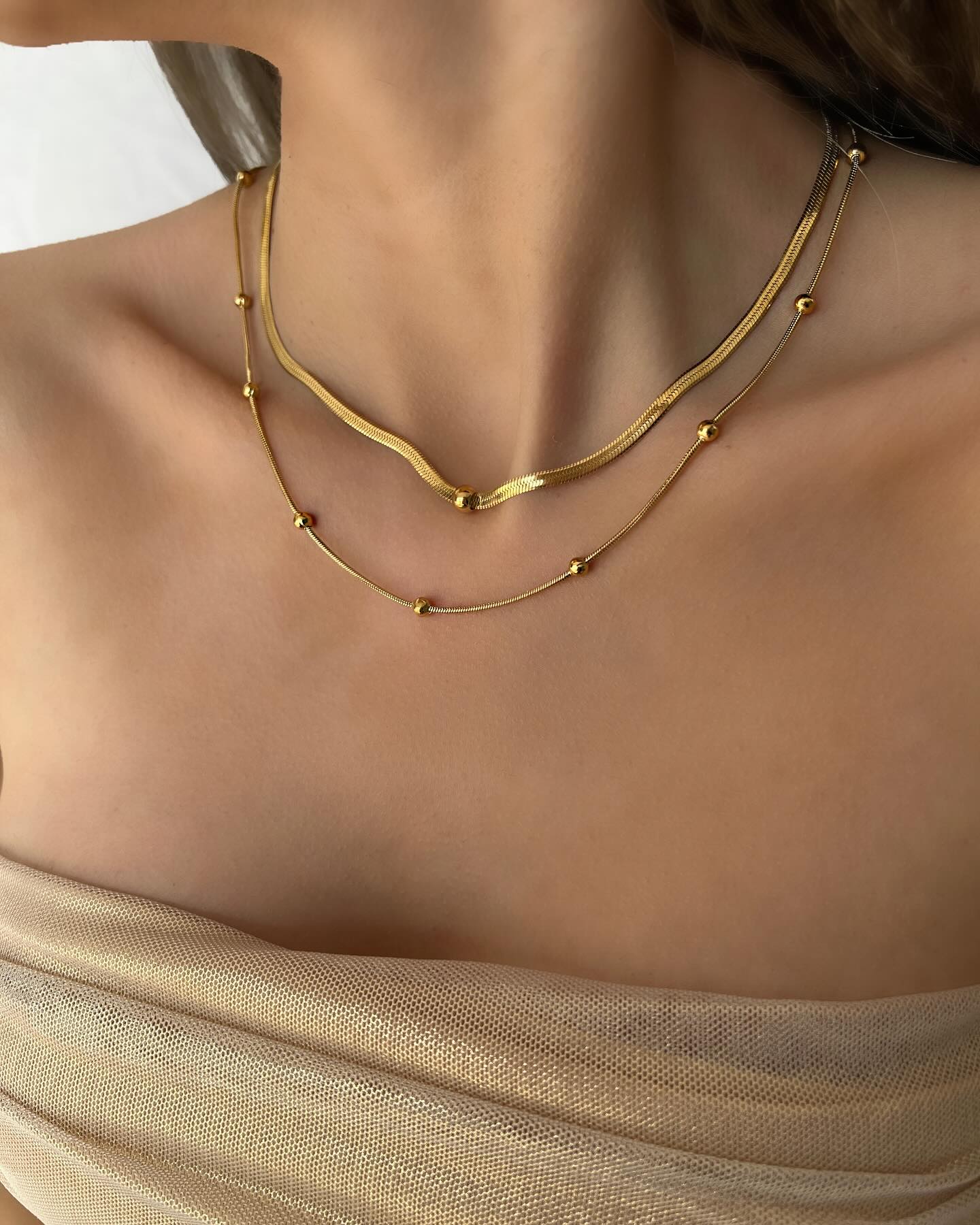 Double waterway design on a long chain, a layered necklace that shimmers with refined elegance.