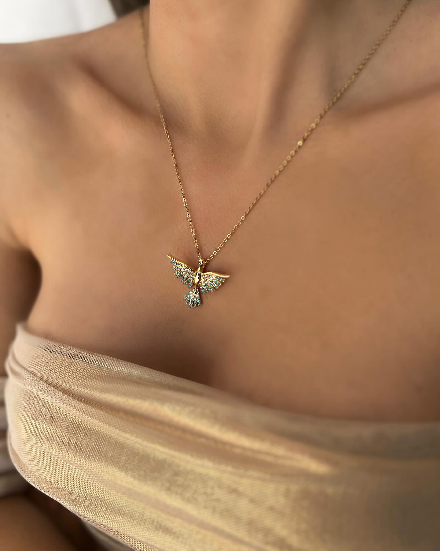 Phoenix charm design, a symbolic necklace that represents rebirth and strength.