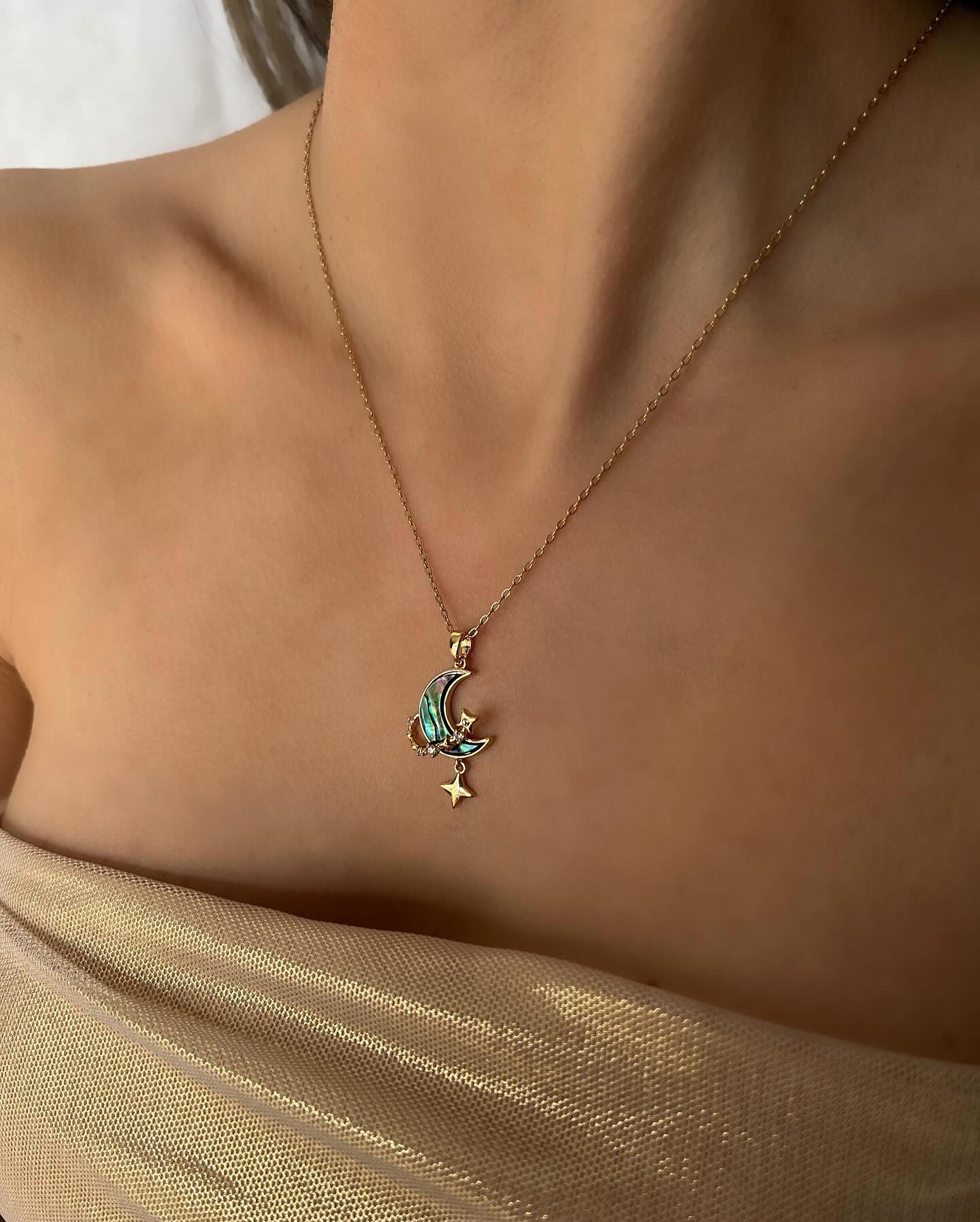 Green moon and star charm, a celestial necklace that blends elegance with a touch of mystique.
