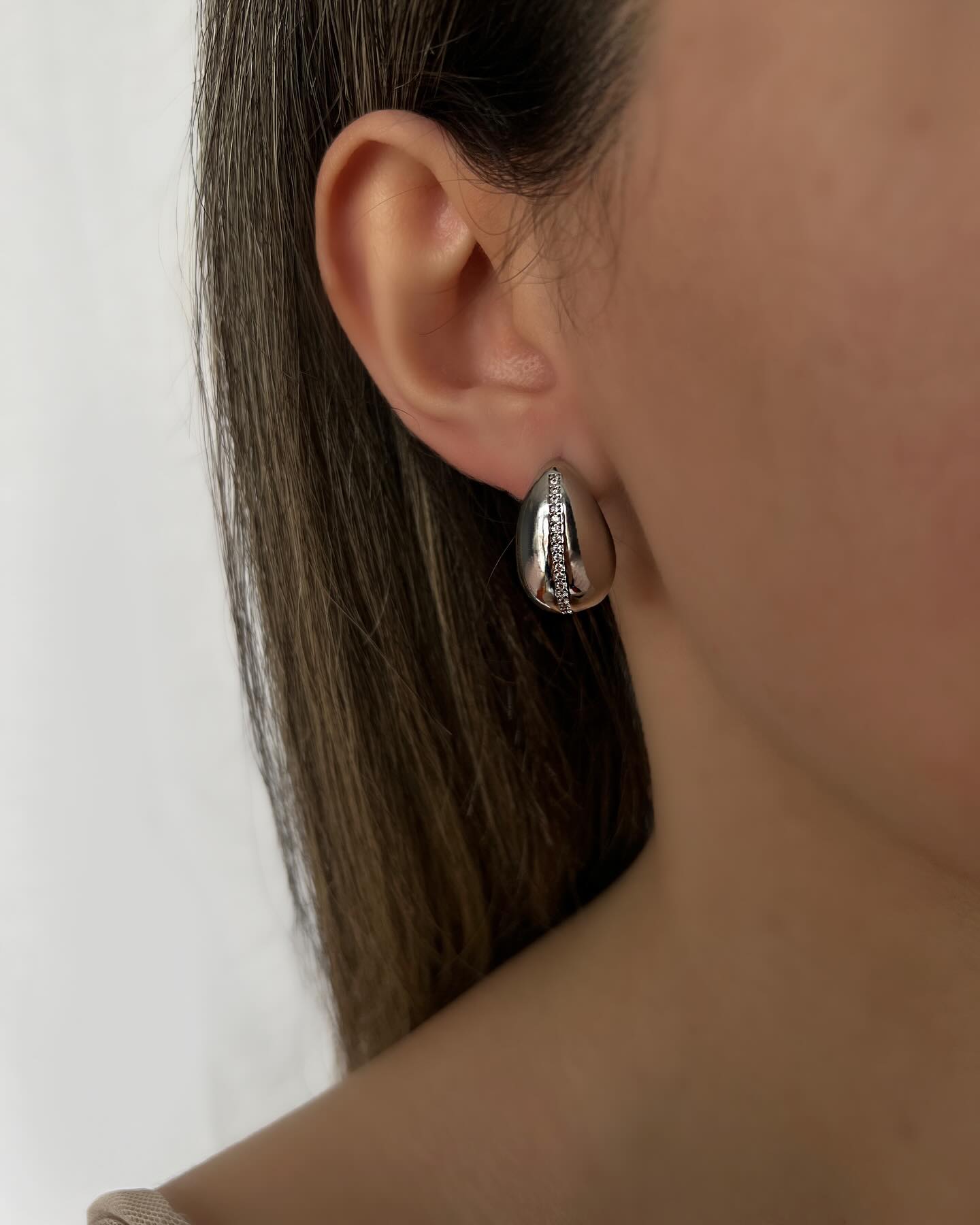 Silver teardrop design, a bold pair of earrings that adds modern sophistication.