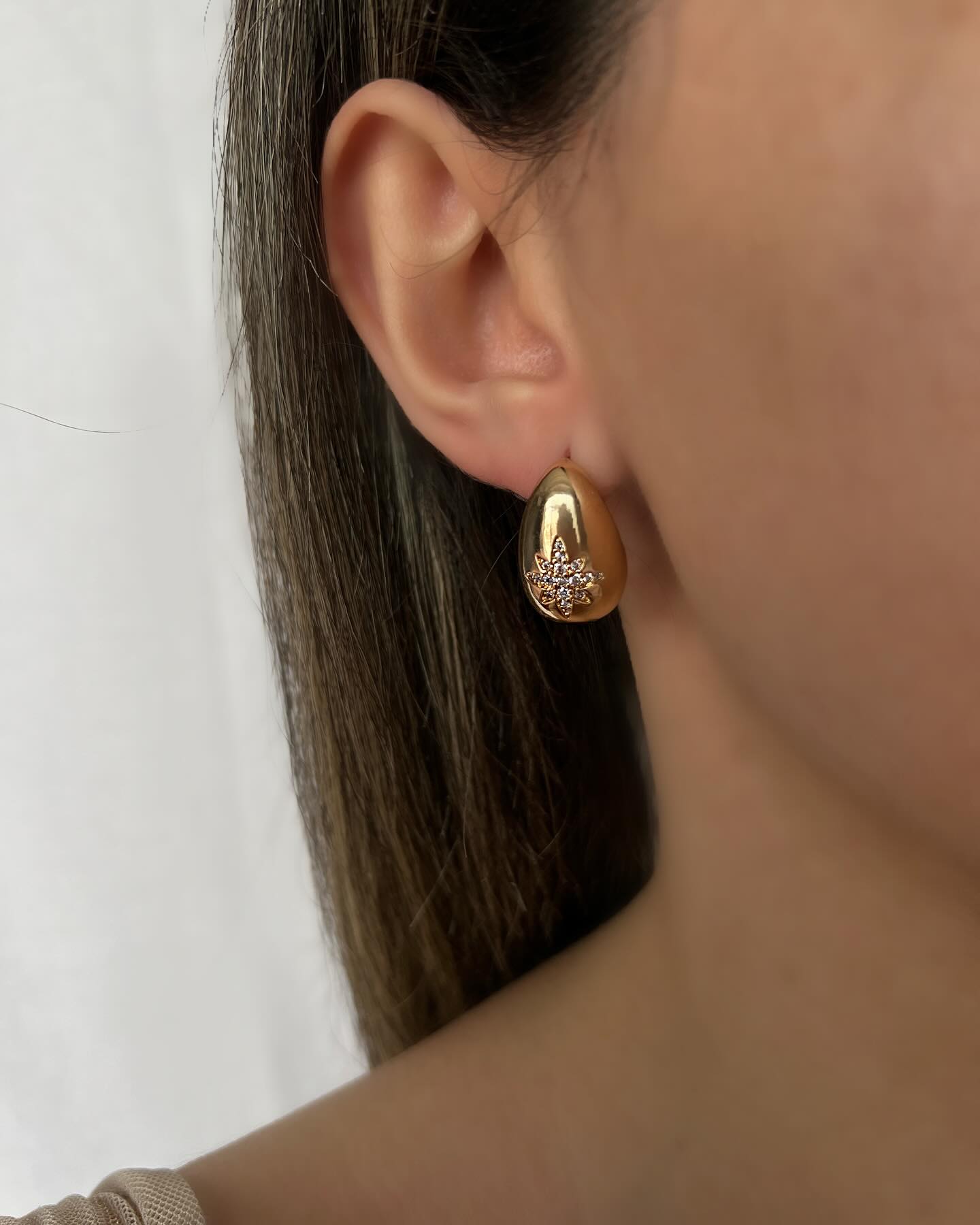Gold teardrop design with diamond accents, a statement pair of earrings that exudes luxury and elegance.