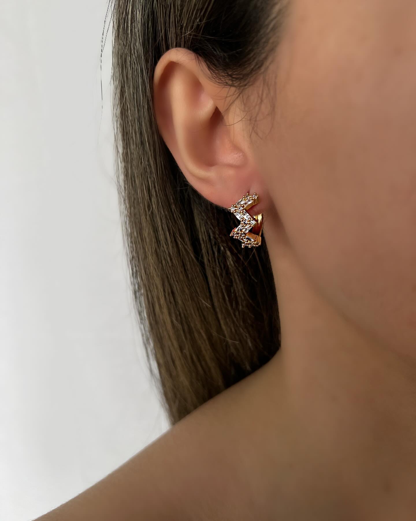 Zigzag design with diamond accents, a modern pair of earrings that shines with bold elegance.
