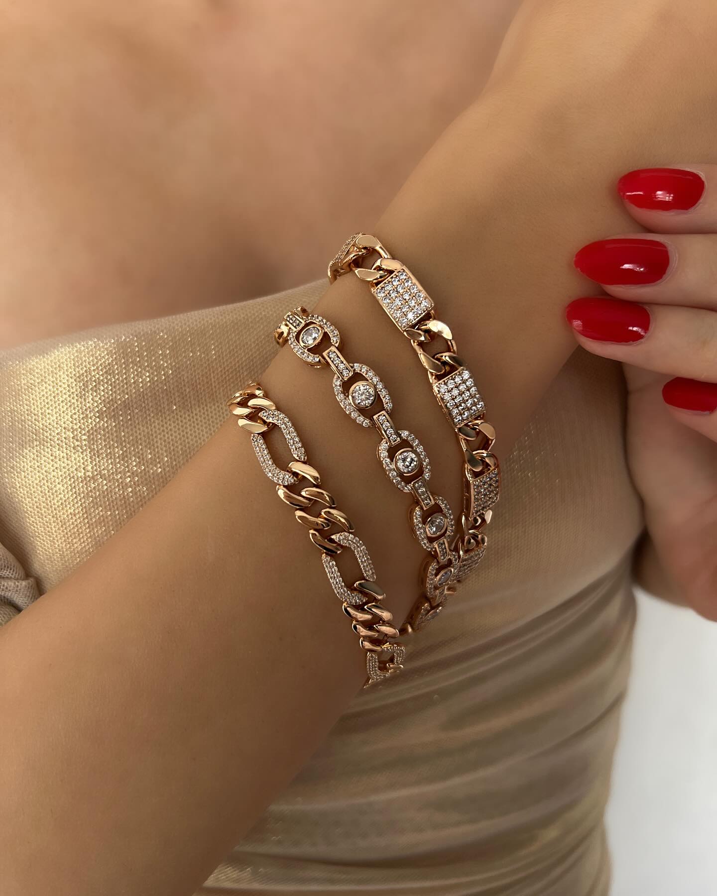 Three gold chain bracelets with diamond accents, a layered design that sparkles with timeless sophistication.