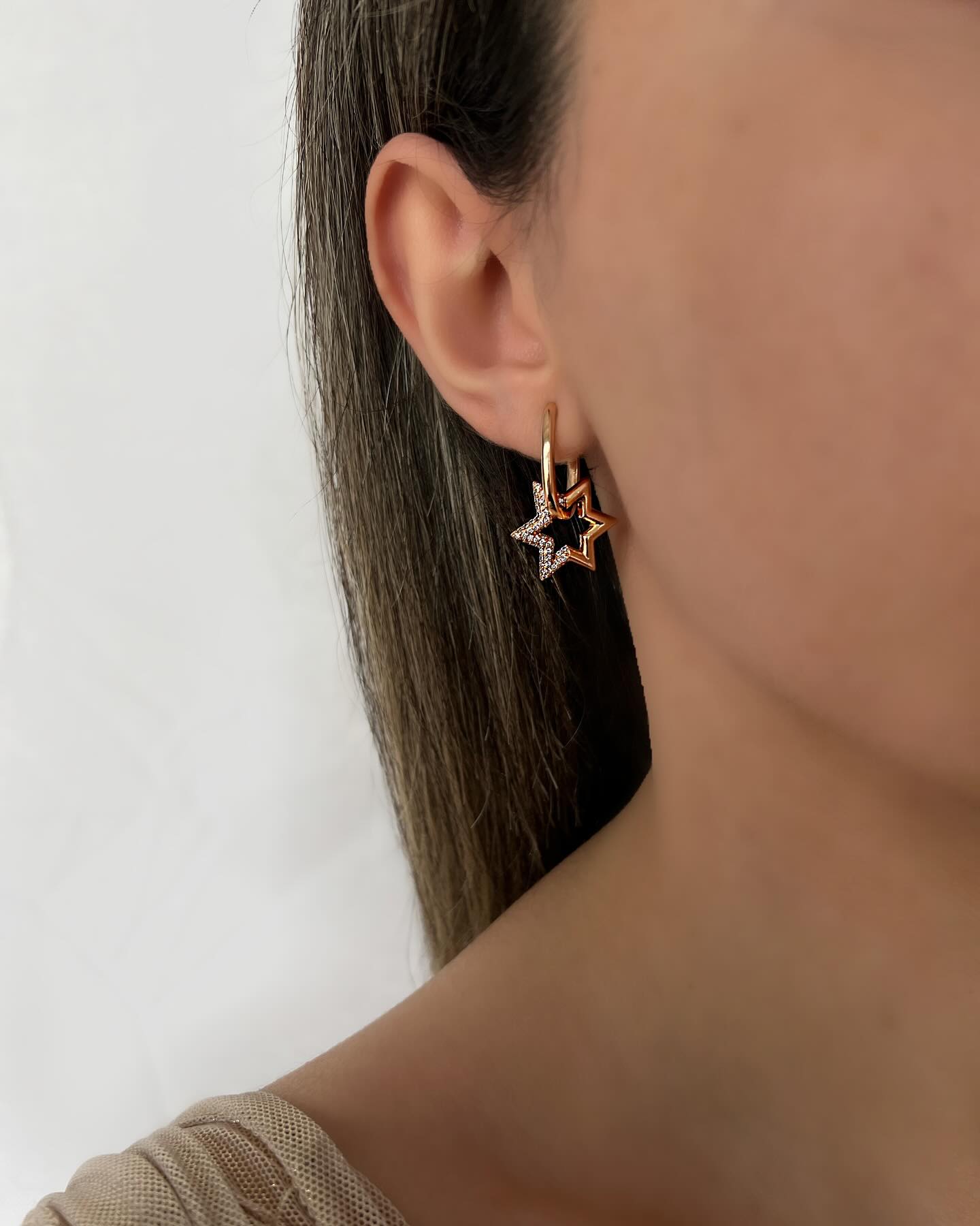 Star charm design, a delicate pair of earrings that sparkles with celestial elegance.