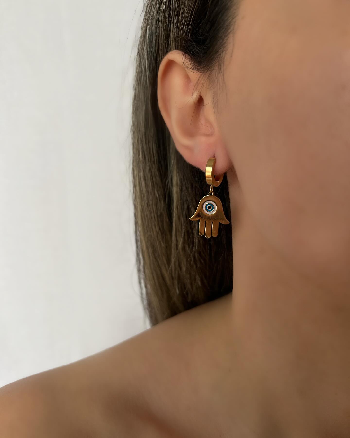 Hamsa hand design in gold, a minimal pair of earrings that symbolizes protection and elegance.