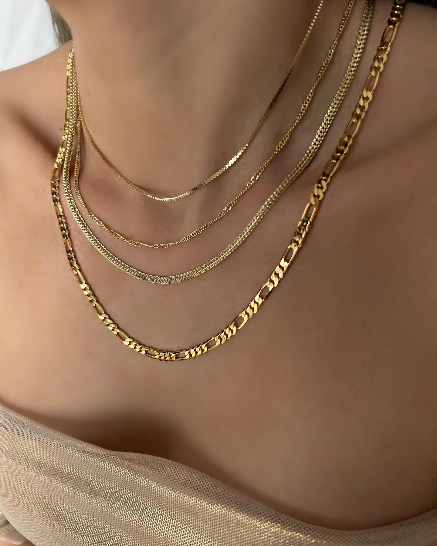 Set of five thin and long Italian chains, a layered necklace that exudes effortless sophistication.