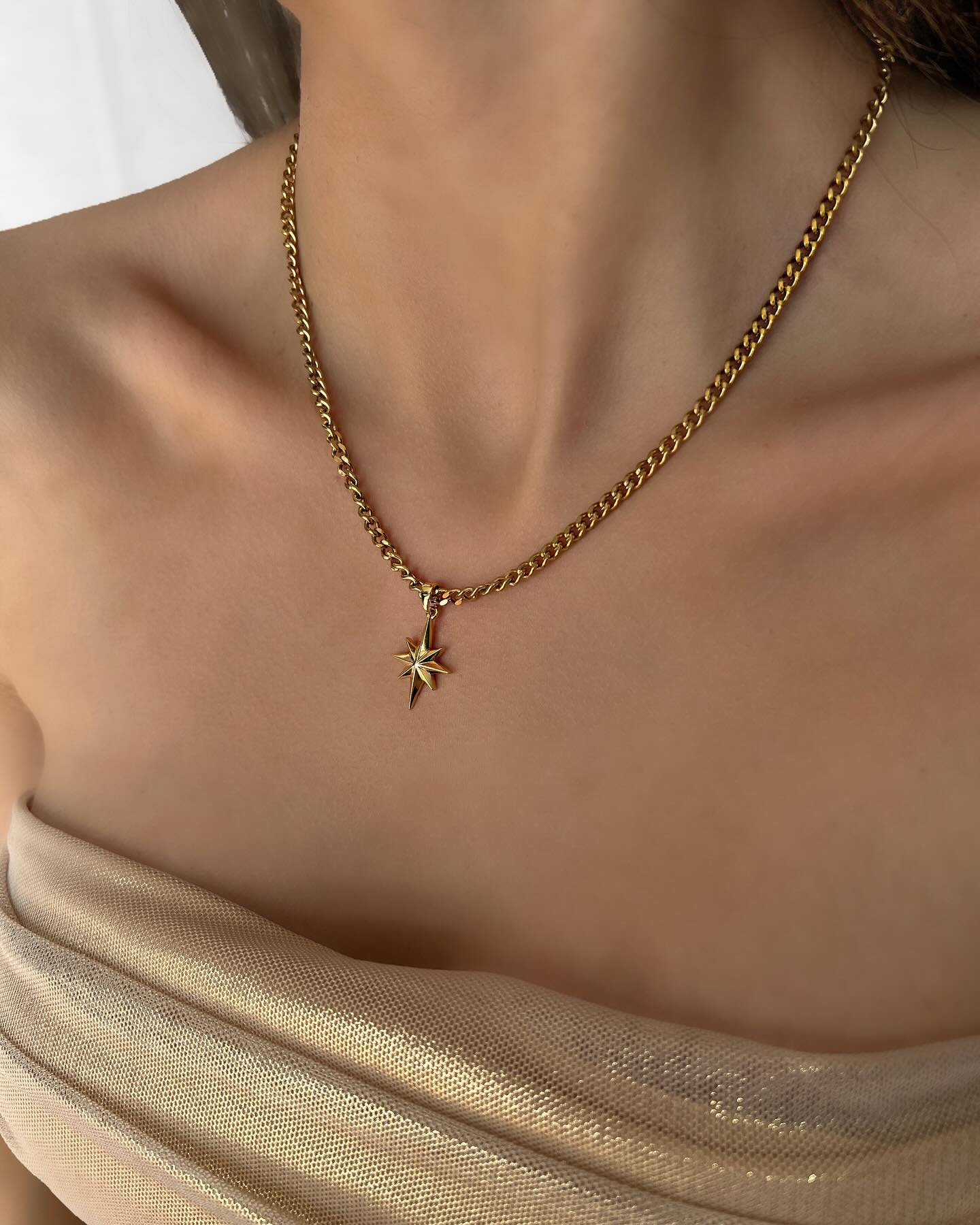 North Star charm on a long chain, a celestial necklace that shines with timeless elegance.