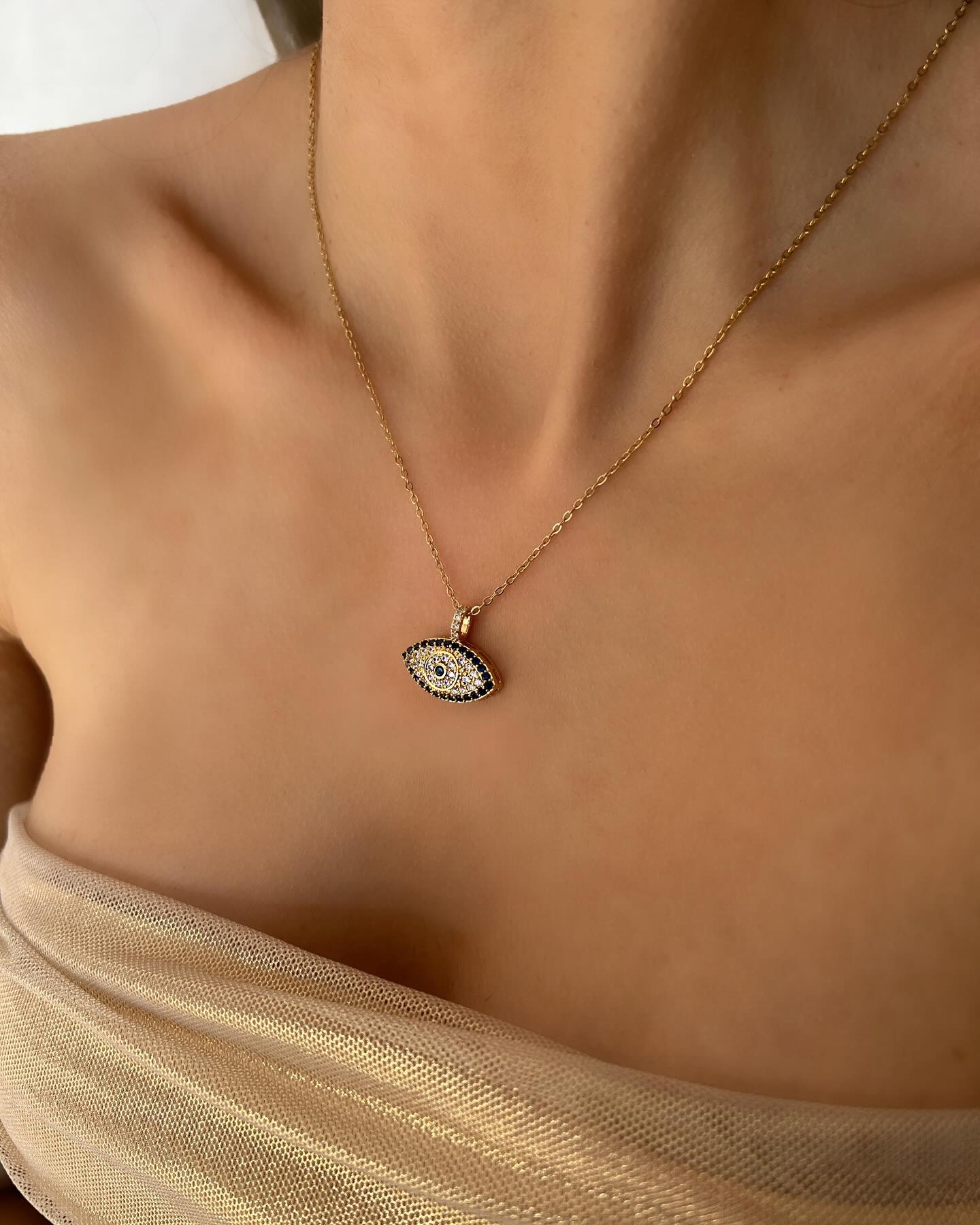 Diamond-accented evil eye design, a radiant necklace that combines elegance with protective charm.