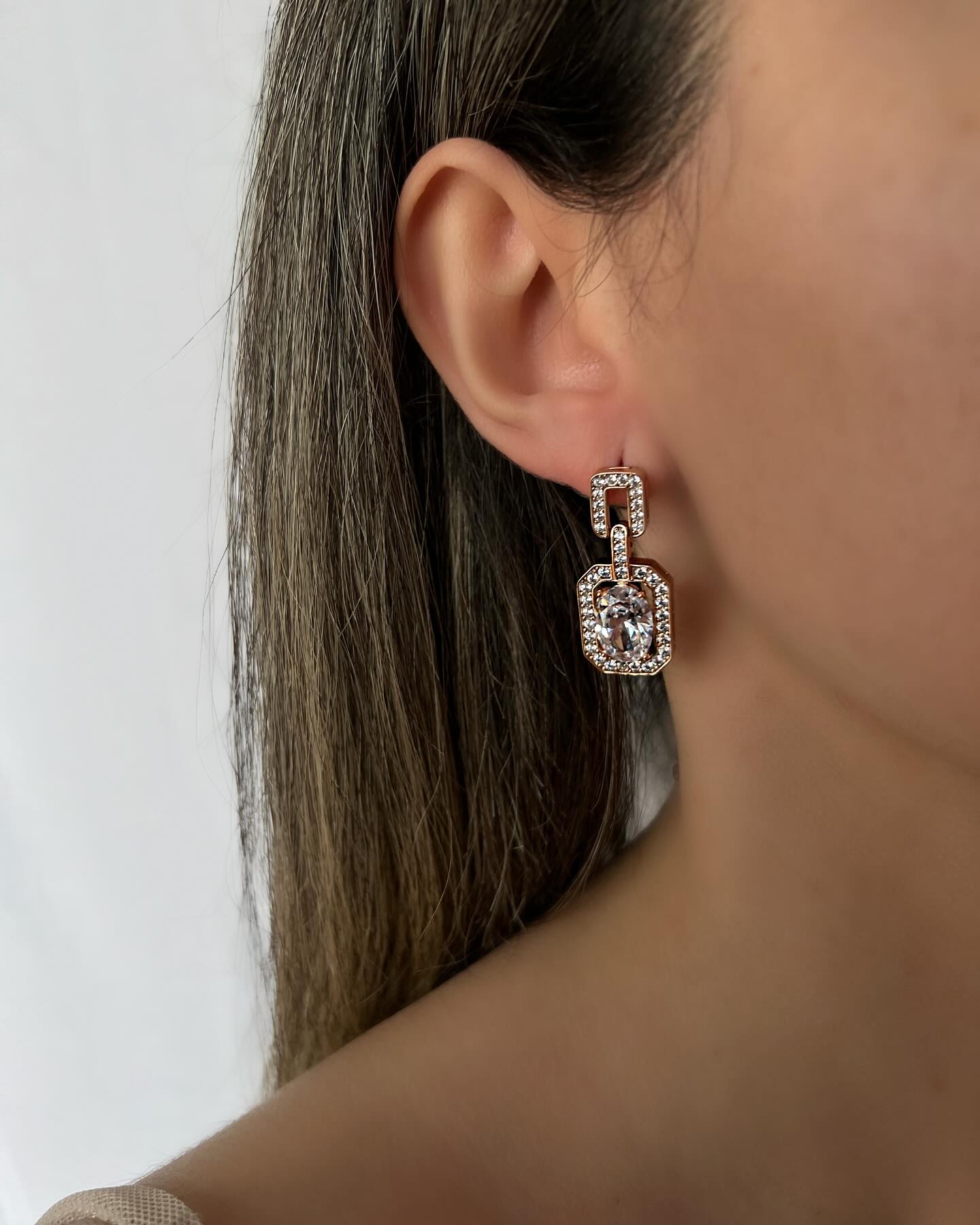 Large diamond within a square design, a striking pair of earrings that exudes modern elegance.